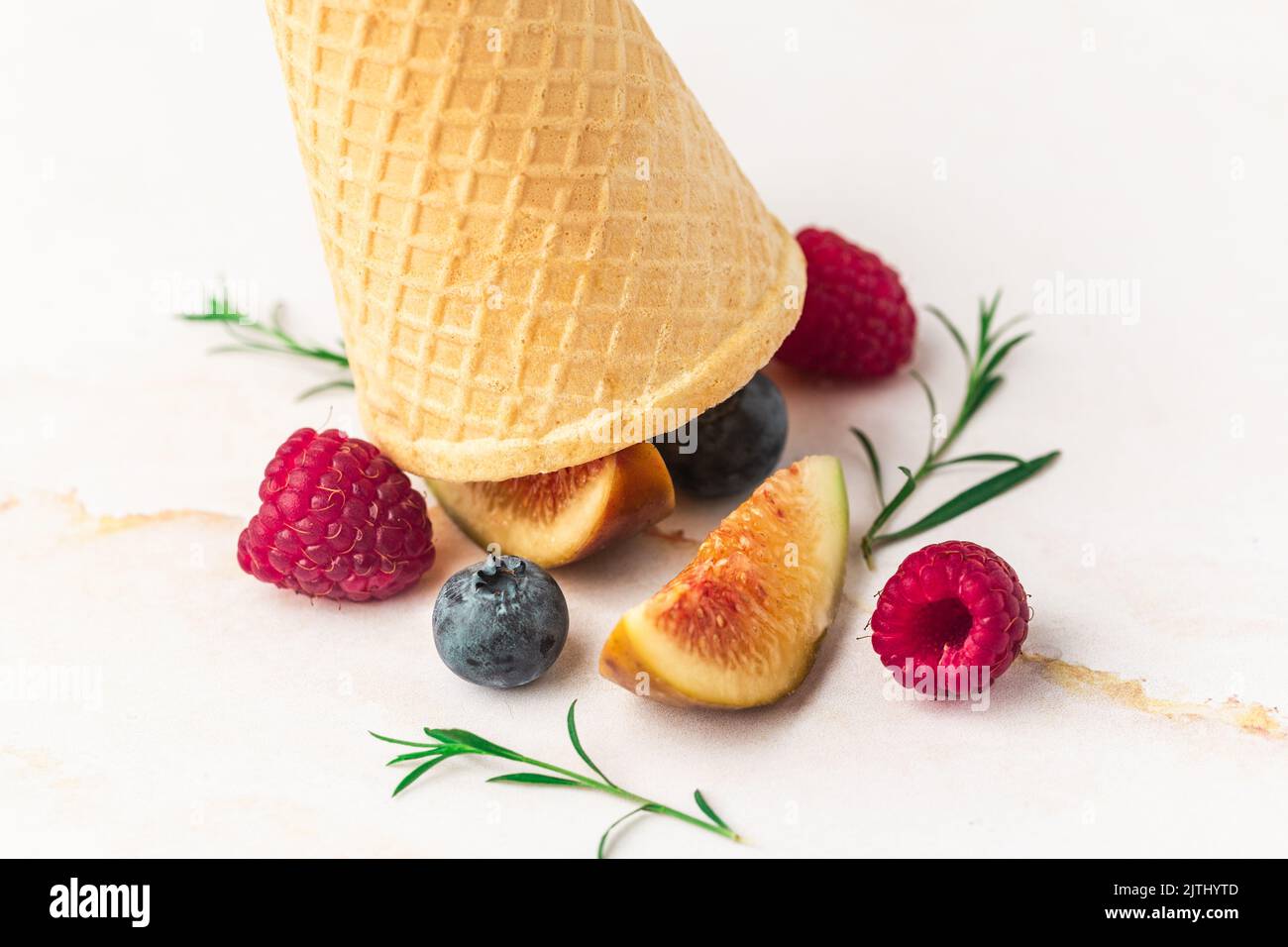 Ice cream cones with berries. Fresh berry fruit, top view of figs, blueberry, raspberry Stock Photo