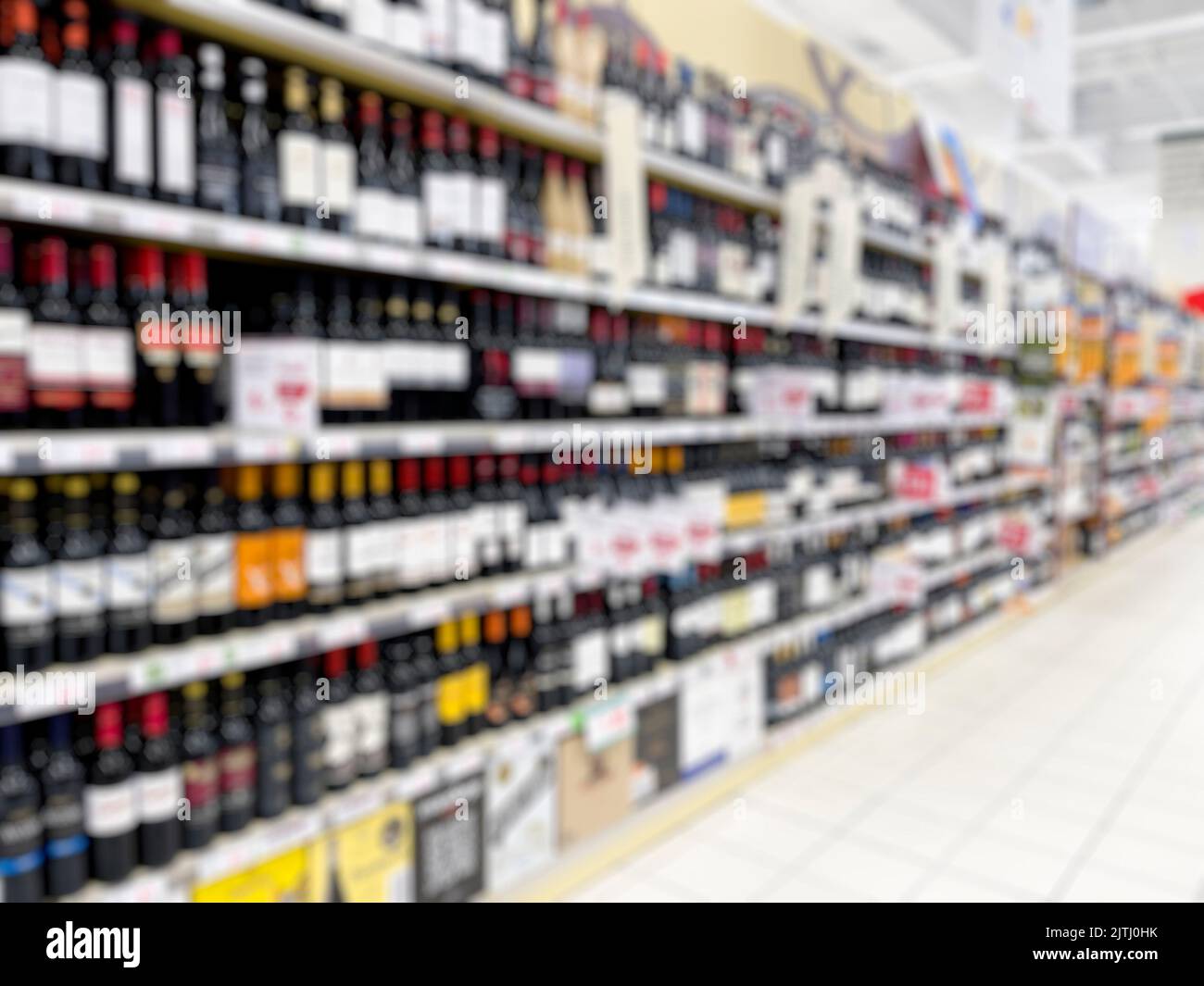 Abstract blurred supermarket wine aisle for background. - stock photo Stock Photo