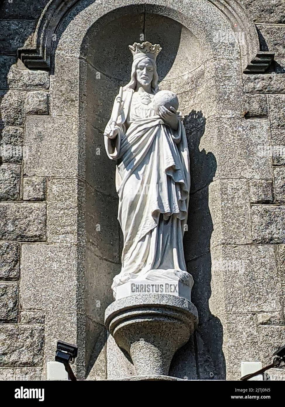 Statue of Jesus above the door of a Roman Catholic church, Northern Ireland. Stock Photo