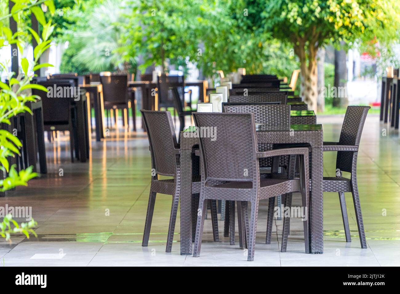 Outdoor tables and chairs, empty beach restaurant table. Rattan style