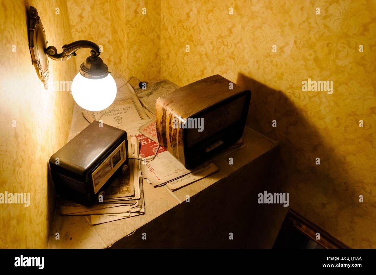 Two old radios in the corner of a room with sheet music. Stock Photo