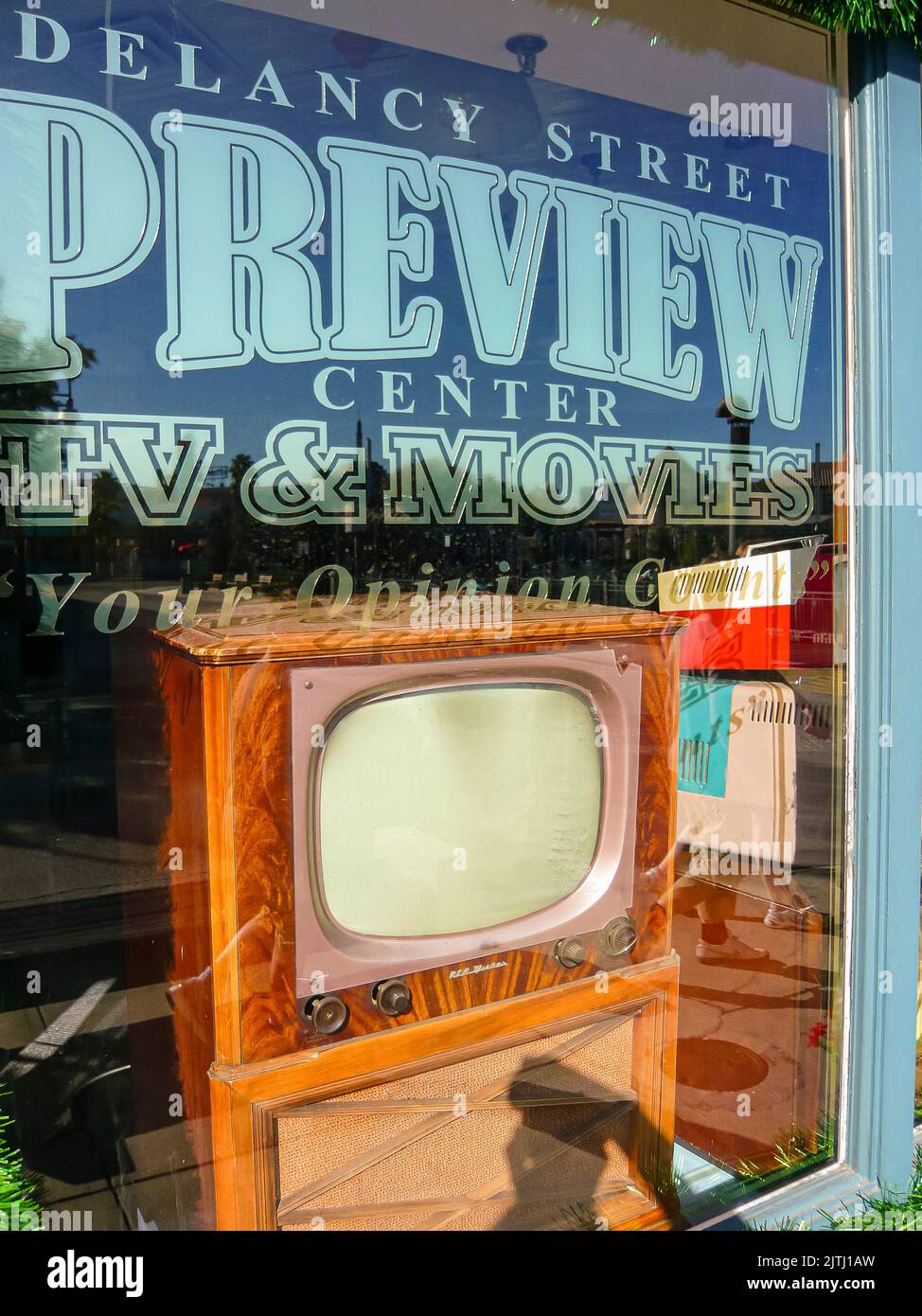 Old fashioned television shop with an old wooden television in the window Stock Photo