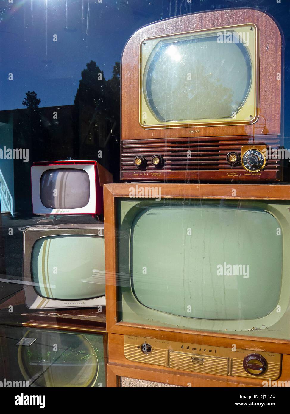 Old fashioned television shop with an old wooden television in the window Stock Photo