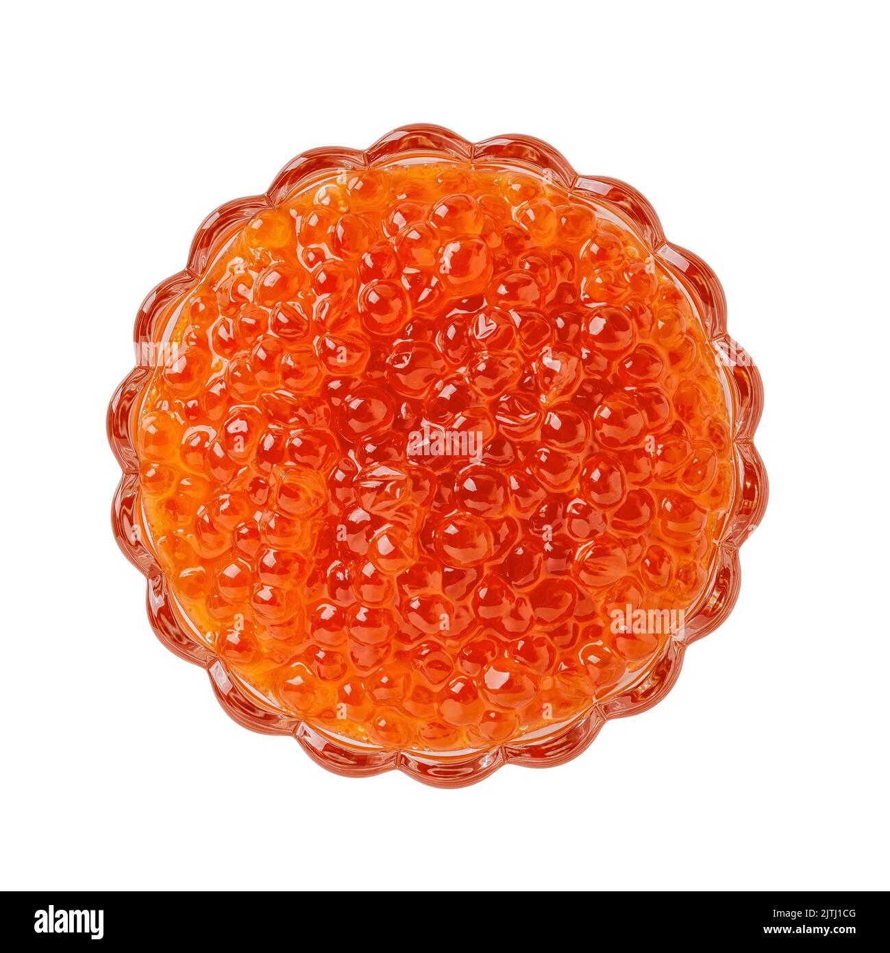 Red caviar in a glass bowl isolated on a white background. Crystal dish full of chum salmon caviar cutout. Salted trout roe. Seafood fish delicacy. Stock Photo