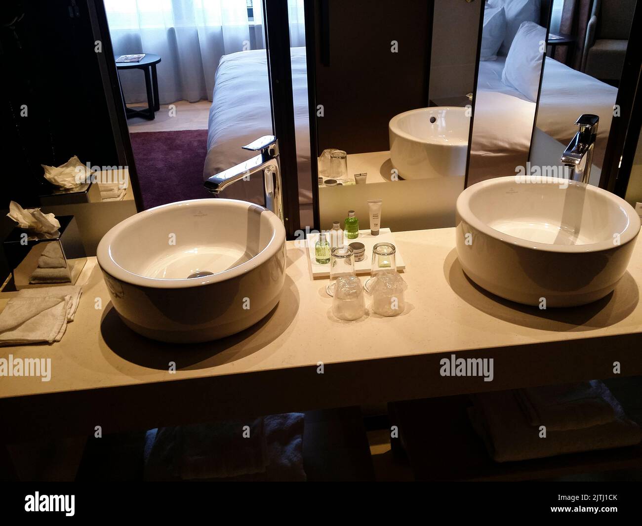 'His and Hers' sinks, with a mirrored wall that opens to reveal the