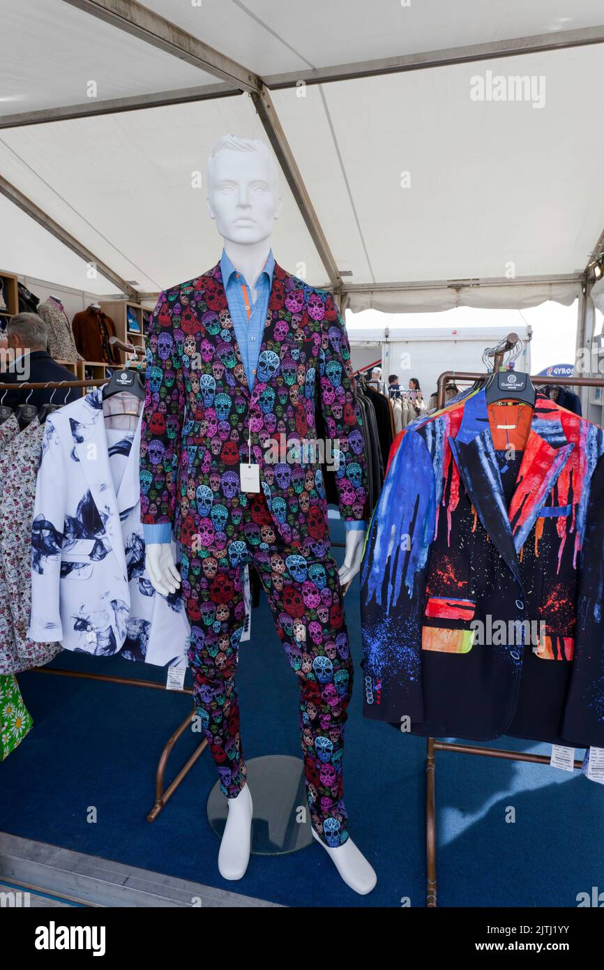 Claudio Lugli's paint-drip printed jacket and multicolour skulls printed suit,  on his stall during the 2022 Silverstone Classic Stock Photo