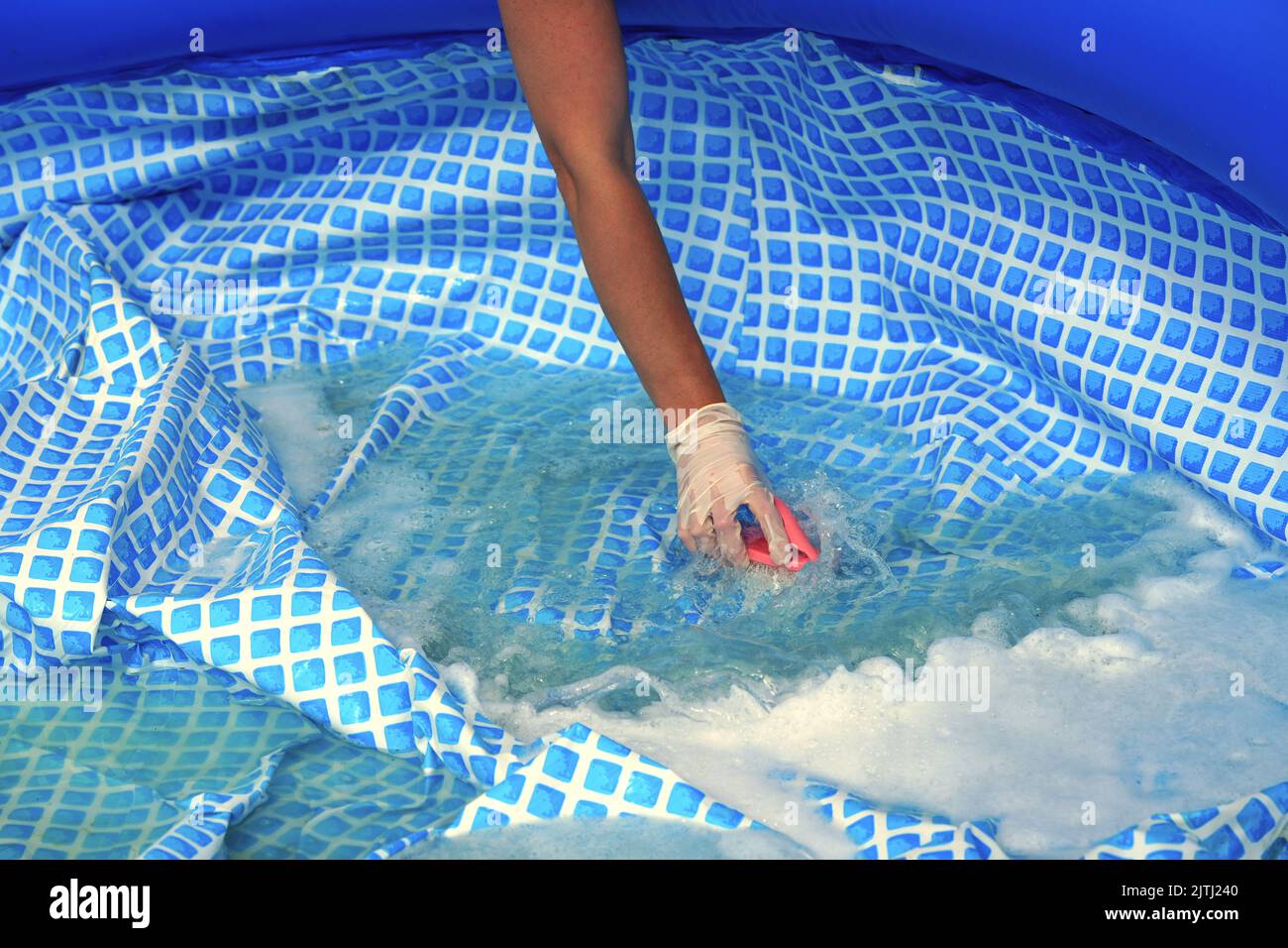 Cleaning pvc inflatable swimming pool, Cleaning the dirty empty pool of algae Stock Photo Alamy