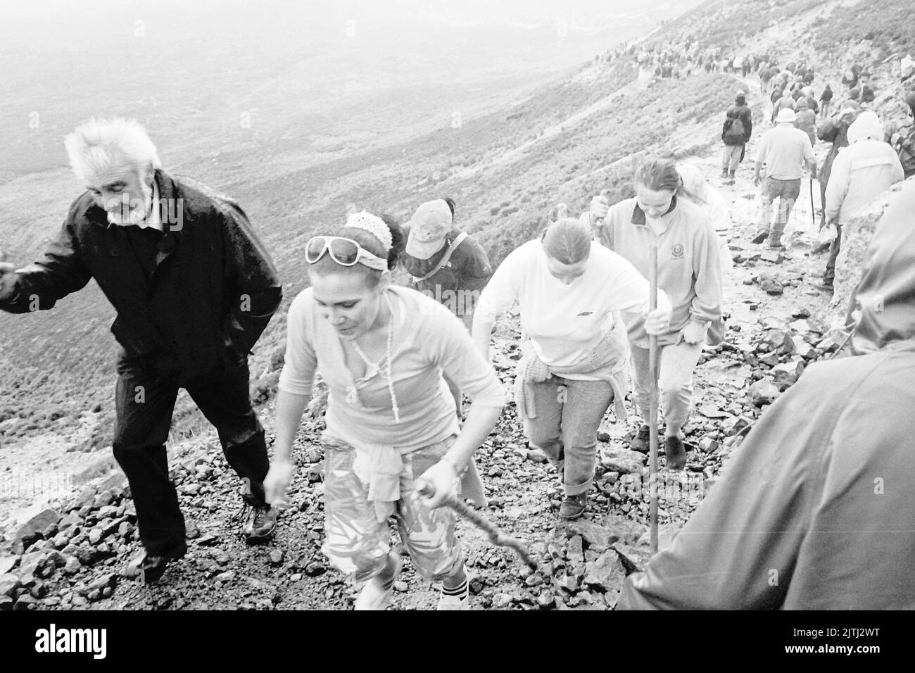 Black and white film footage of 'Reek Sunday', a guelling pilgrimage up Croagh Patrick, County Mayo on the last Sunday in July each year, to visit the location where Saint Patrick stayed for 40 days, and from where his was said to have banished the lizards and snakes from Ireland. Stock Photo