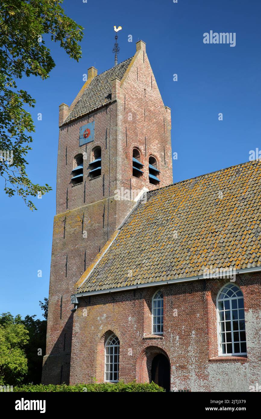 The Reformed Church (Hervormde Kerk) with its massive bell tower in Alligawier, Friesland, Netherlands. Stock Photo