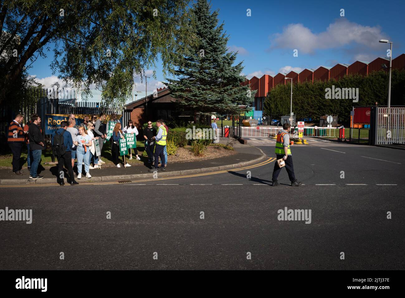 Manchester, UK. 31st Aug, 2022. A man walks past the picket line for the first day of strike action. Reach which publishes several newspapers failed to negotiate a deal away from the proposed 3% offered which is below inflation and during a Cost Of Living Crisis. Credit: Andy Barton/Alamy Live News Stock Photo