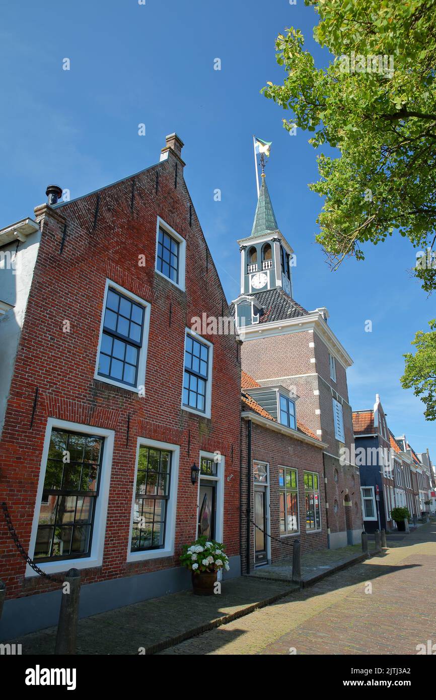 The historical Weigh House (Waag) in the historical center of Makkum, Friesland, Netherlands, with historical houses Stock Photo