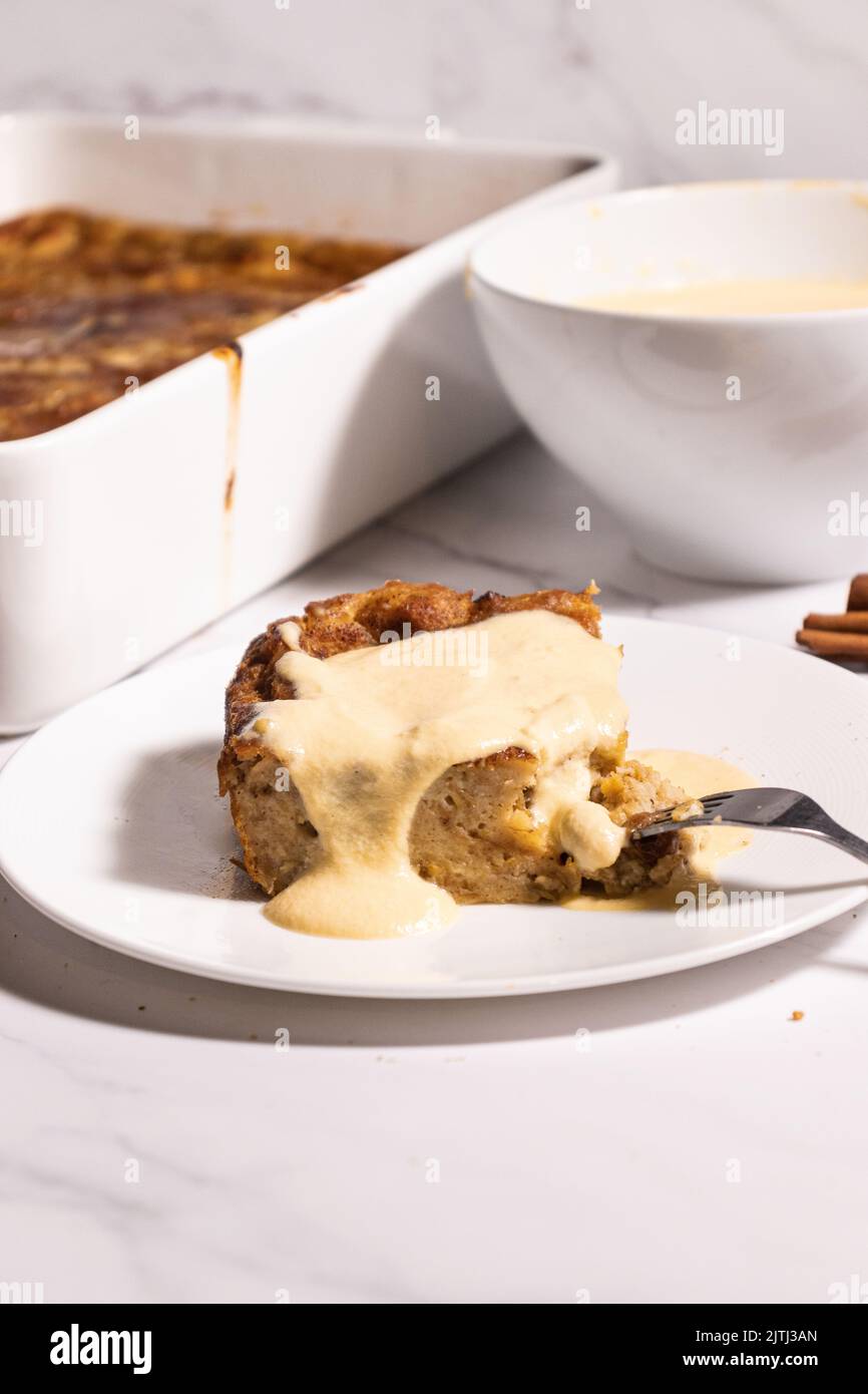 A slice of bread pudding with vanilla custard sauce Stock Photo Alamy