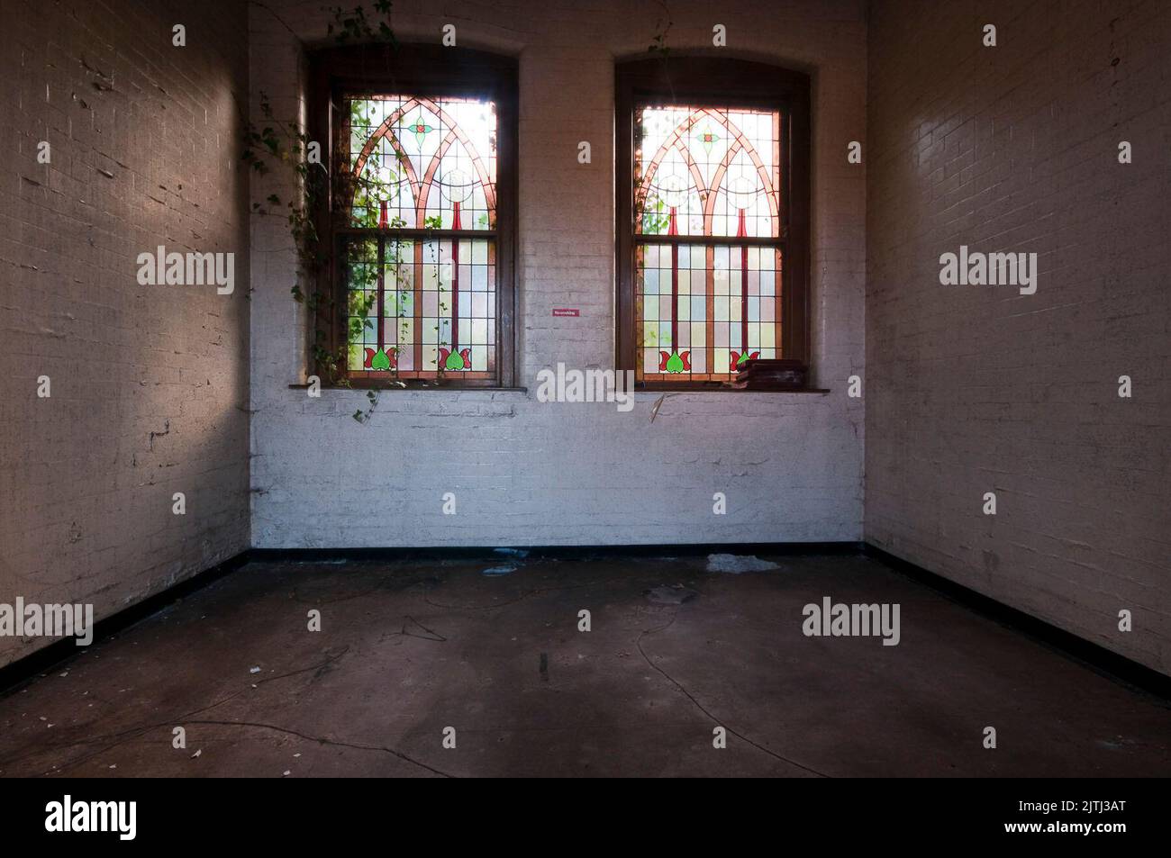 Room with stained glass windows in an abandoned disused hospital mortuary. Stock Photo