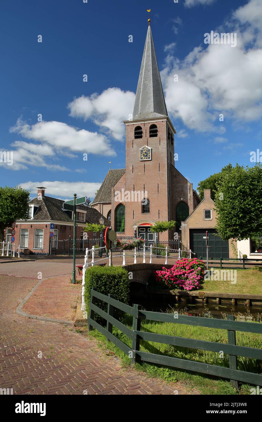 Mauritiuskerk church, located along Eegracht canal in IJlst, Friesland, Netherlands Stock Photo