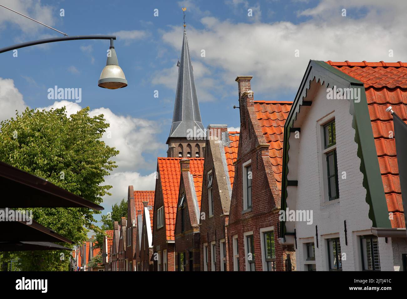 The historic center of Balk, Friesland, Netherlands, with a raw of historic houses, and the tower of the Raadhuis (former town hall built in 1615) Stock Photo