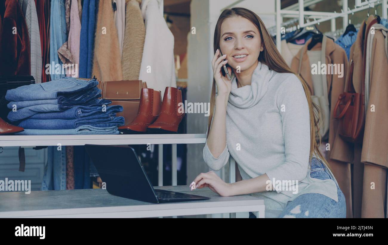 Clothing store owner talking with influencer and showing apparel in stock  to create advertisement. Shopping mall worker chatting with fashion blogger  and displaying garment for promotion 33861713 Stock Photo at Vecteezy