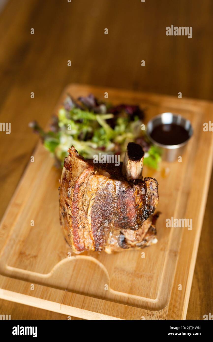 Big piece of beef rib on a wooden table Stock Photo
