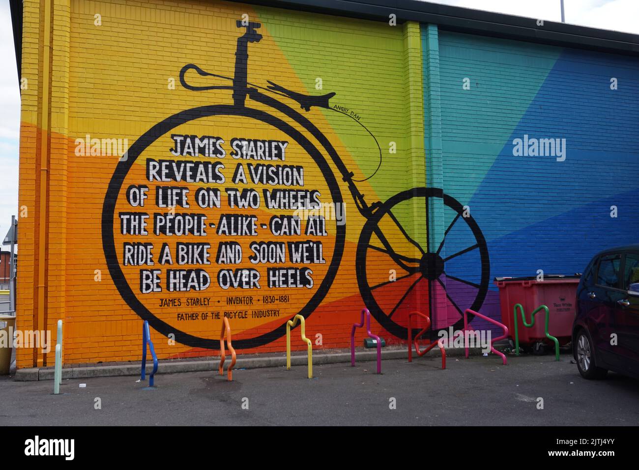 Old fashioned Penny Farthing bicycle wall mural in Coventry, UK Stock Photo