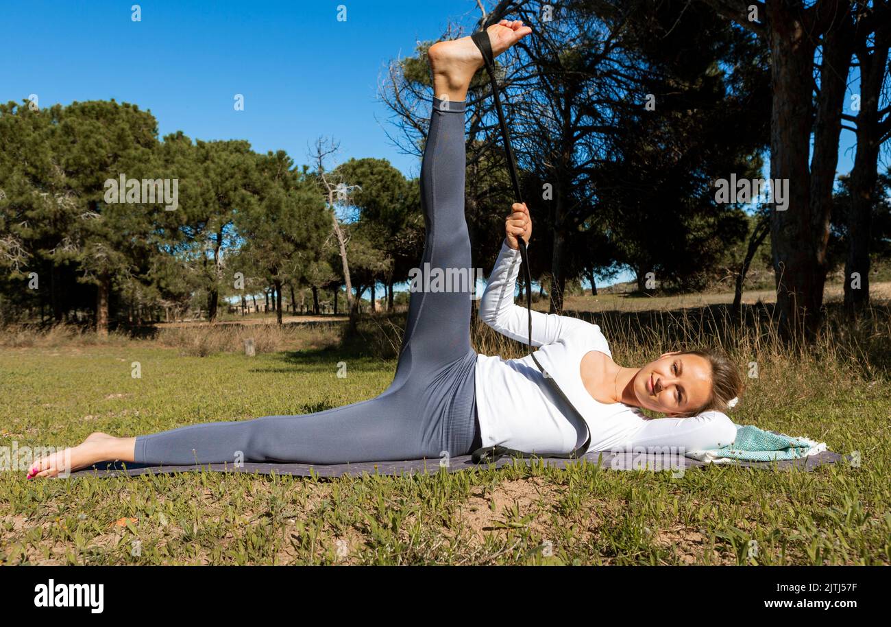 beautiful woman exercising with a rubber band in nature Stock Photo