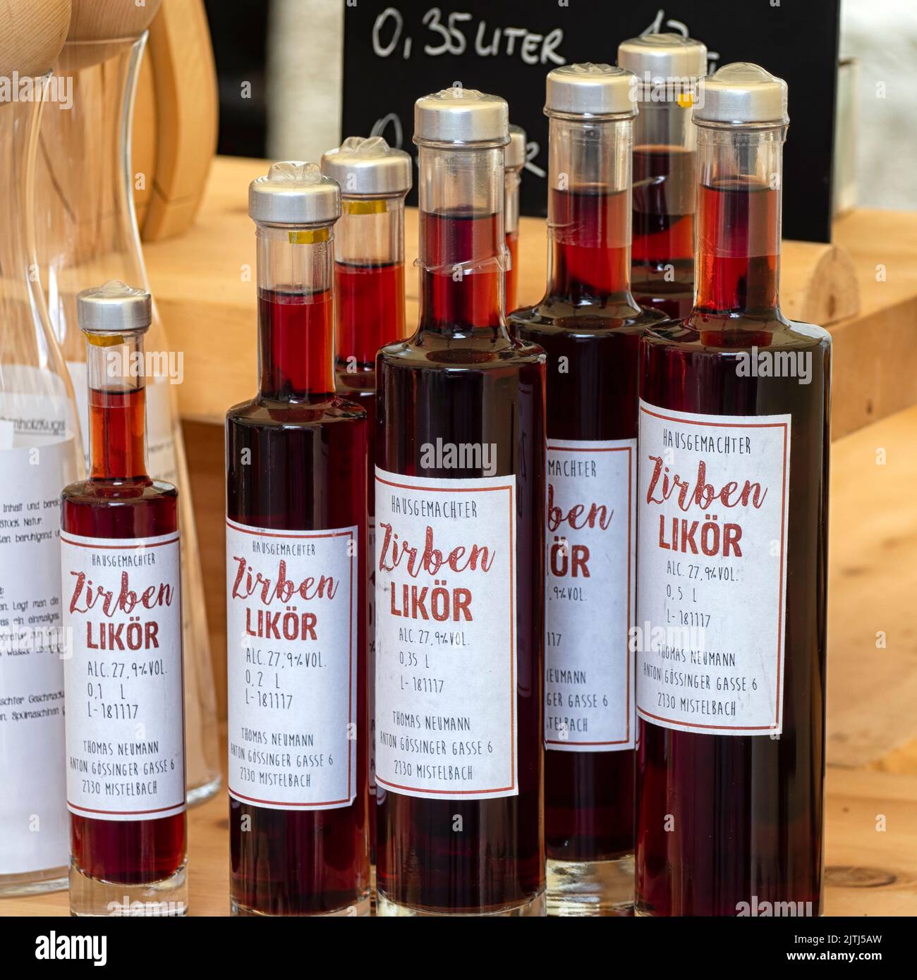 KREMS, AUSTRIA - JULY 13, 2019:  Bottles of Pine Liqueur (Zirben Likor) at a market stall in the Old Town Stock Photo