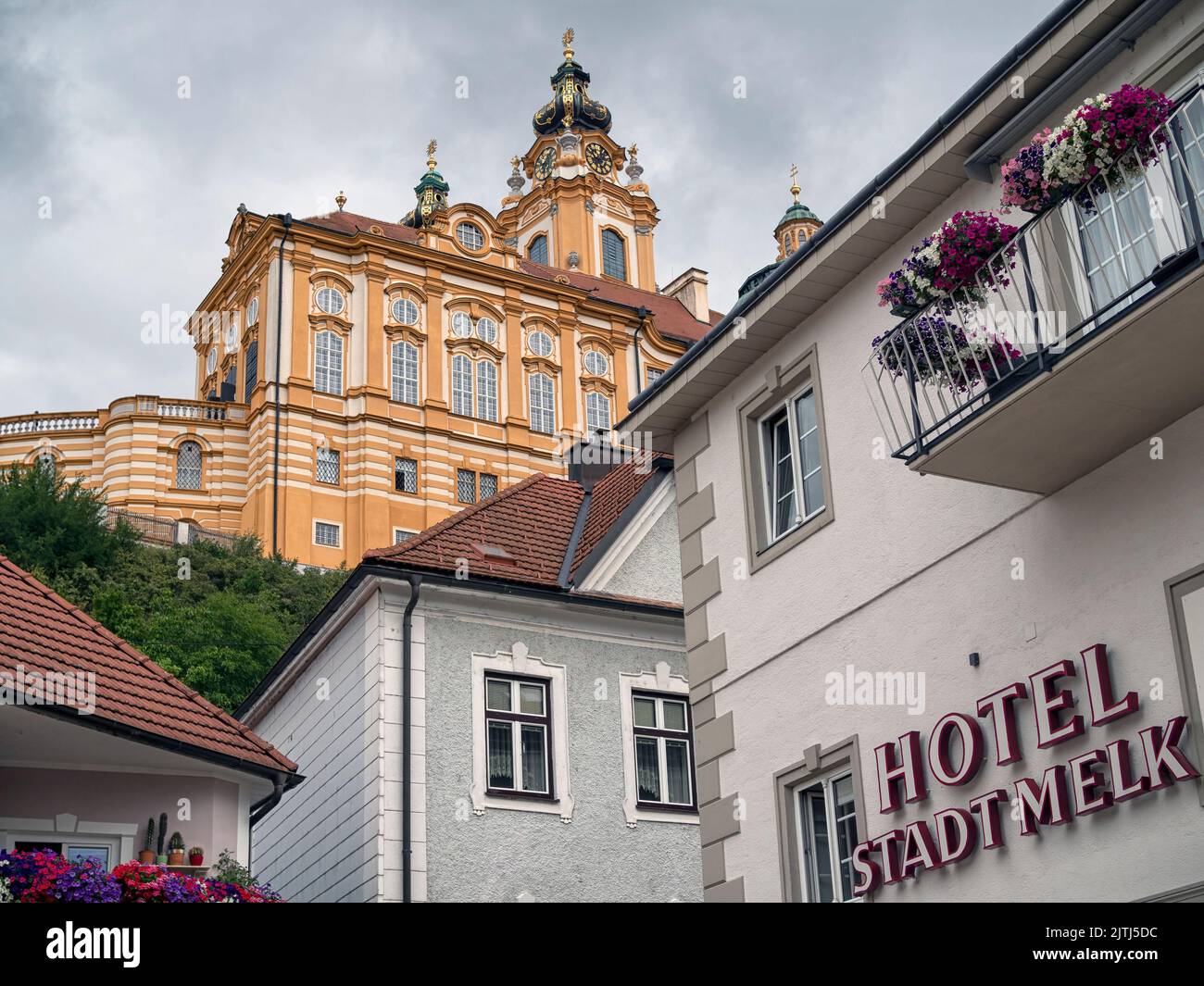 MELK, AUSTRIA - JULY 13, 2019:   Exterior view Hotel Stadt Melk with the Abbey in the background Stock Photo
