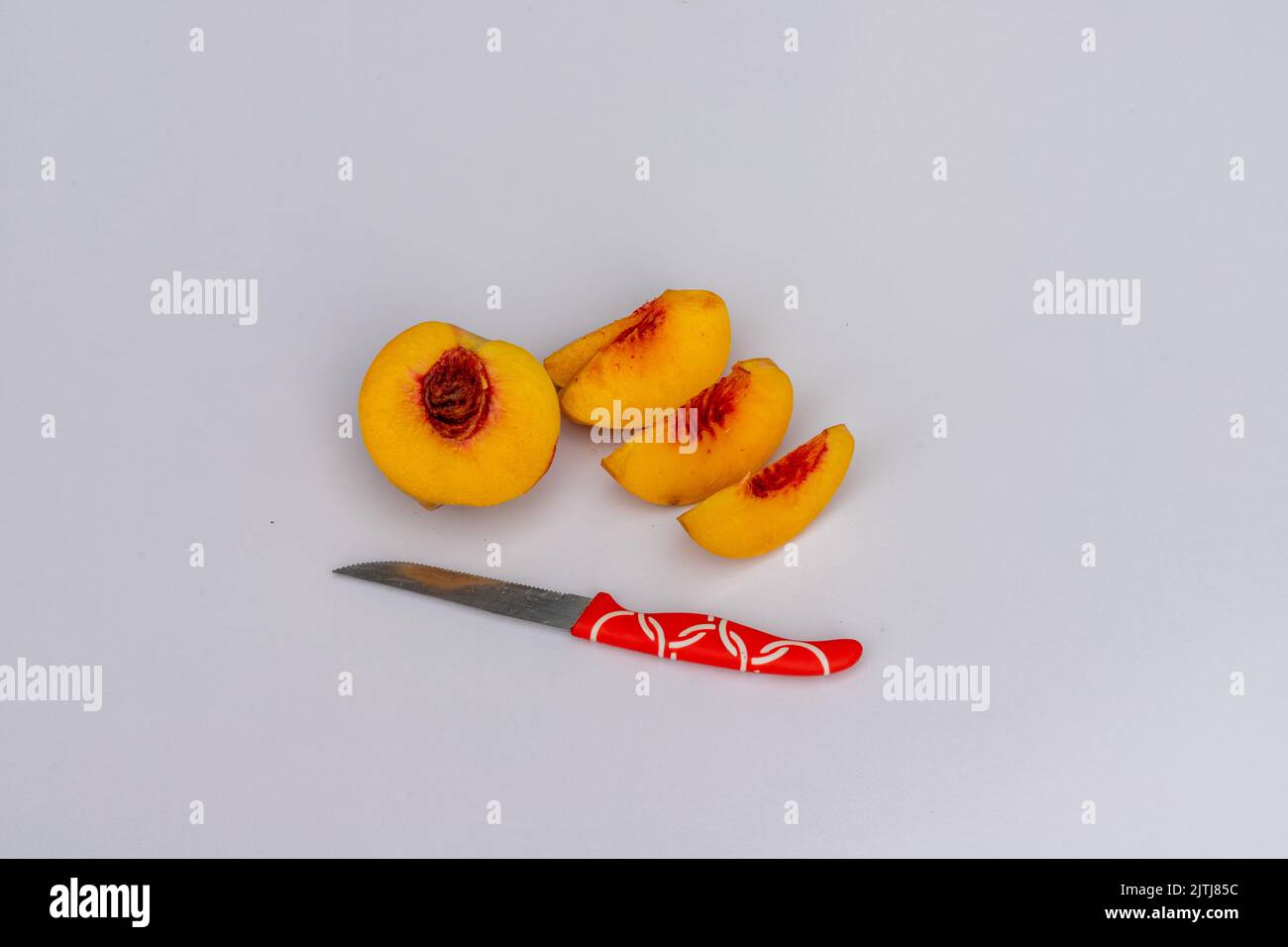 Ripe peach fruit sliced on a white background Stock Photo - Alamy