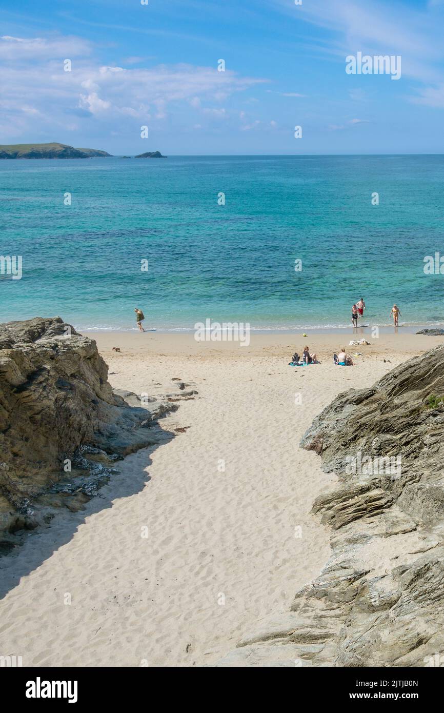 Holidaymakers enjoying the peaceful secluded Little Fistral on the coast of Newquay in Cornwall in the UK. Stock Photo