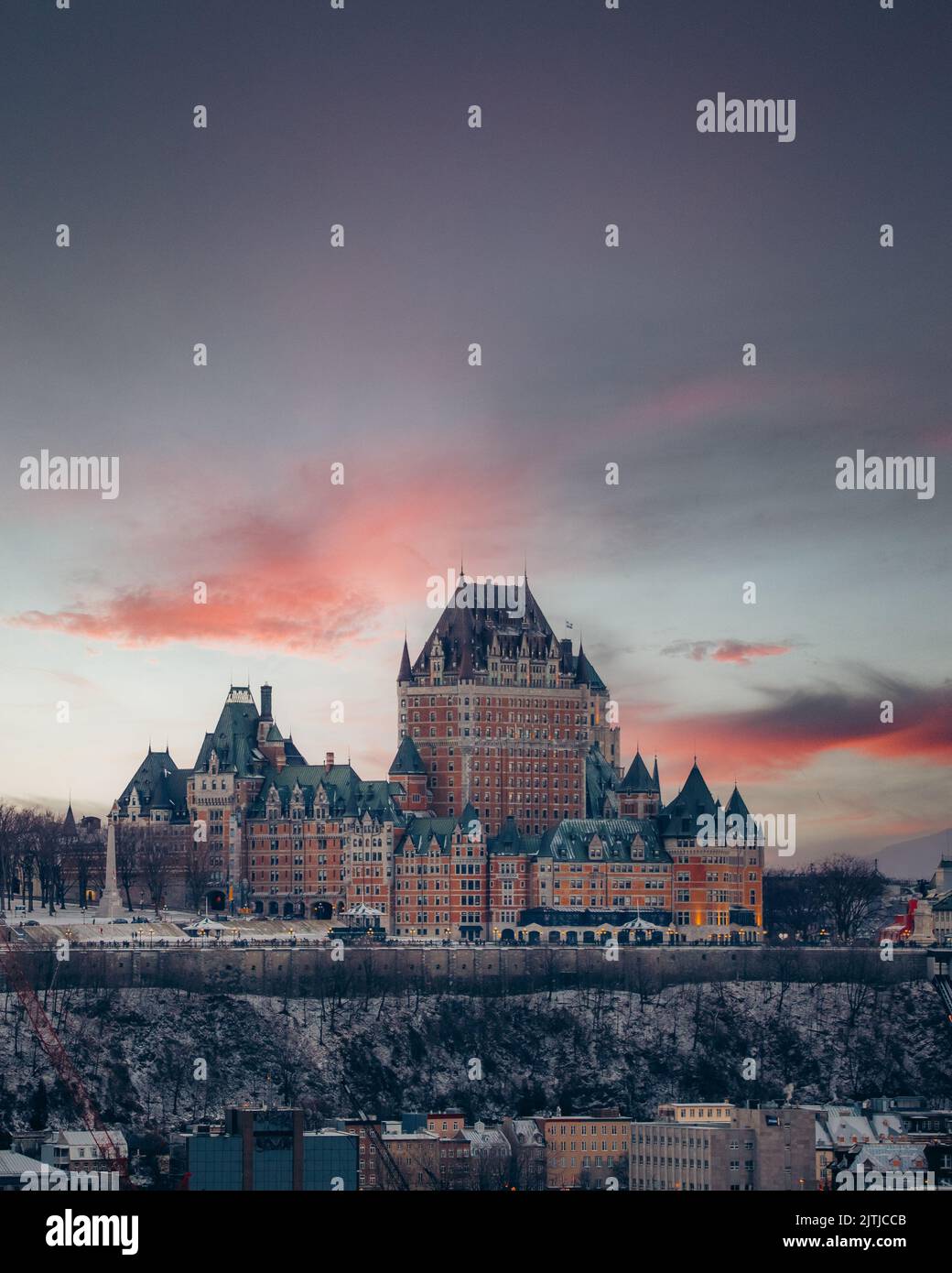 Quebec Background A vertical breathtaking view of old castle on pink sunset sky ...