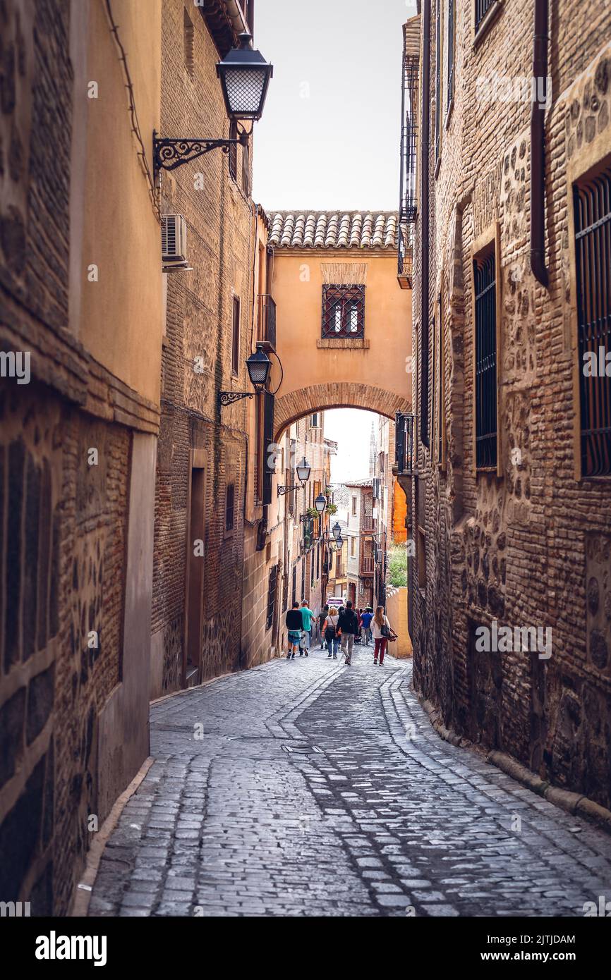 A vertical shot of the narrow Angel street in Toledo Stock Photo - Alamy