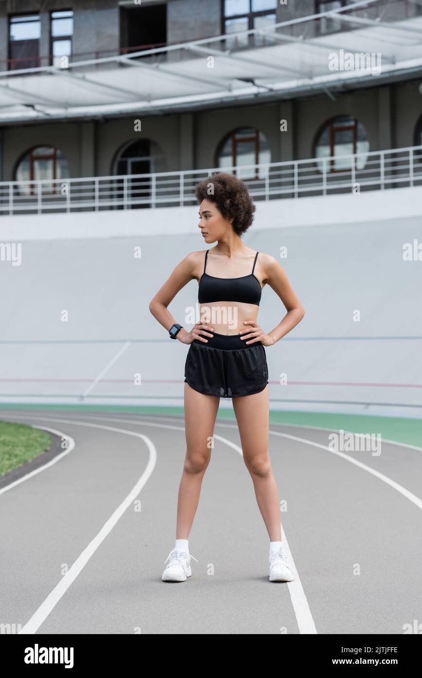 full length of african american woman in black sportswear and white ...