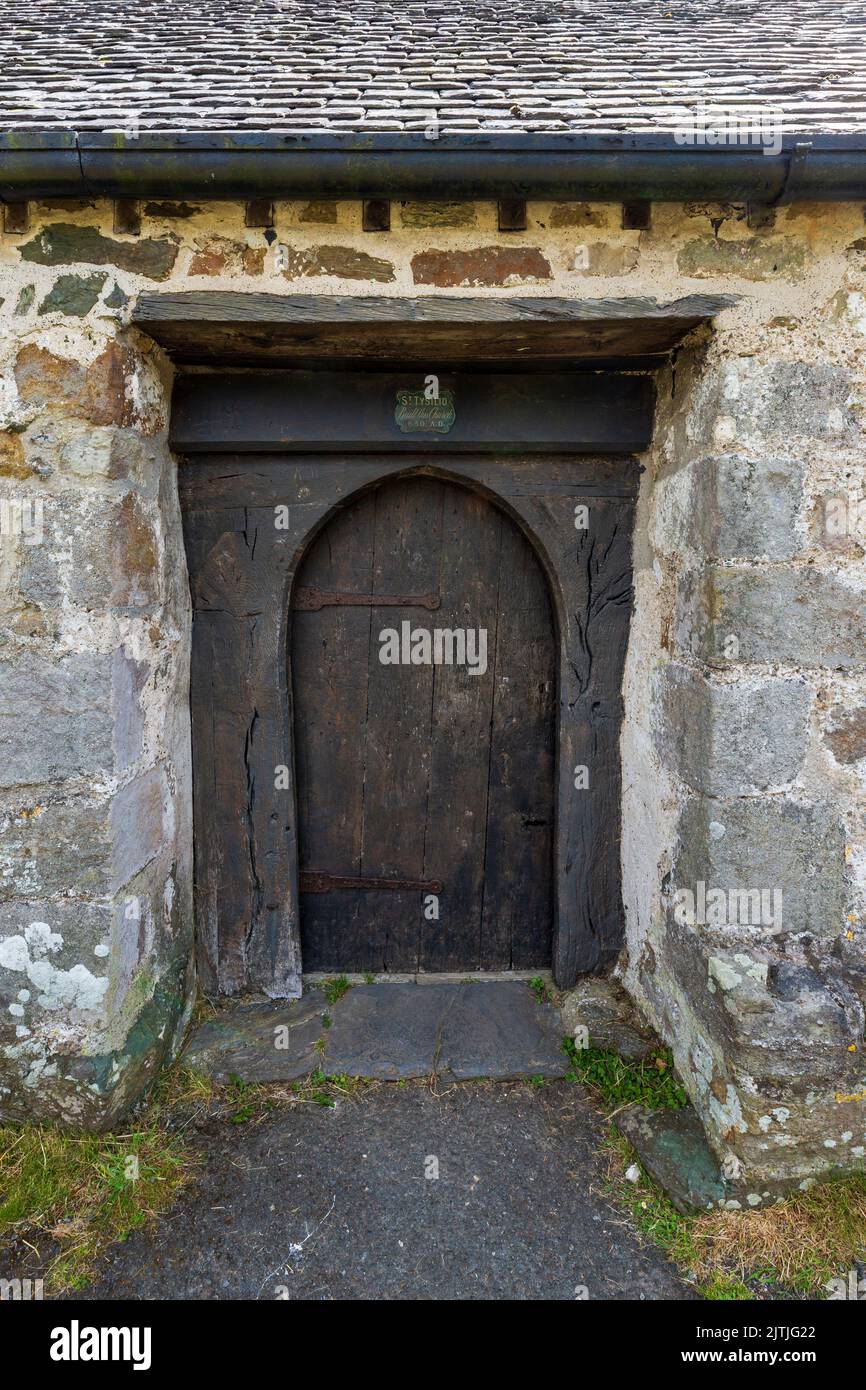 The old wooden entrance doorway to St Tysilio's Church on Church Island in the Menai Strait, Isle of Anglesey, North Wales Stock Photo