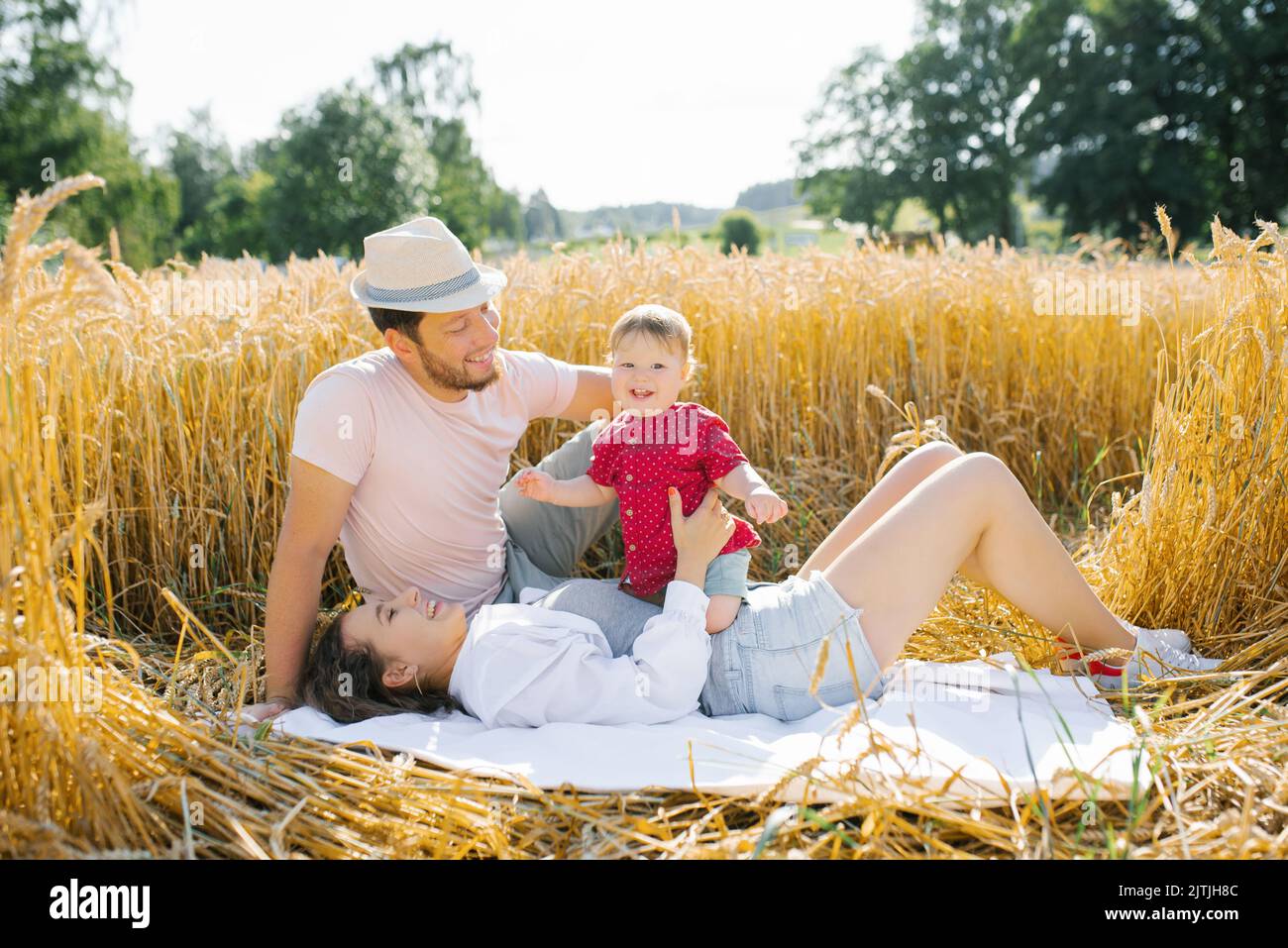 Happy young family with a young son have fun in the summer in the field Stock Photo