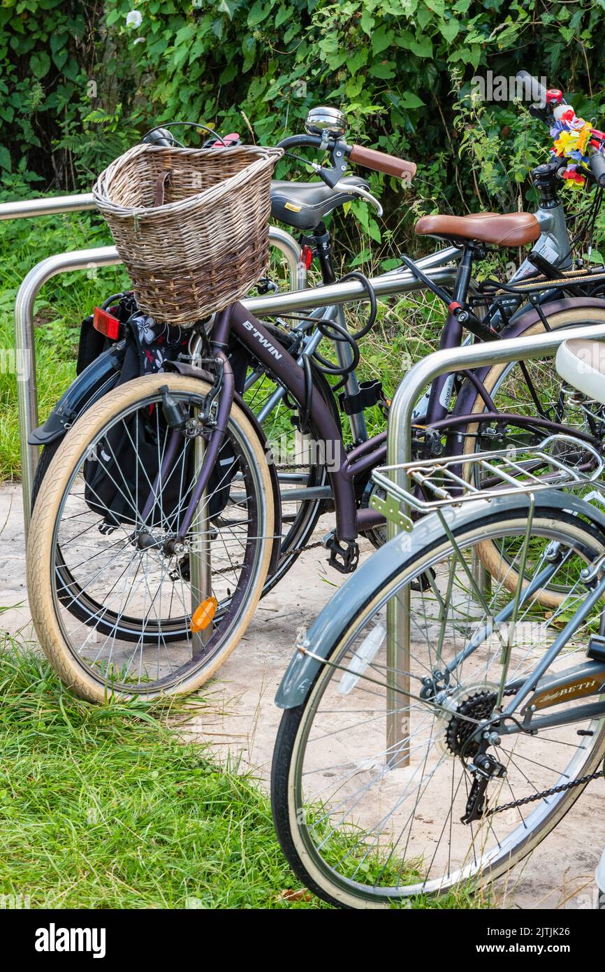 Bicycles parked in a bicycle rack at a country park in Wales Stock Photo