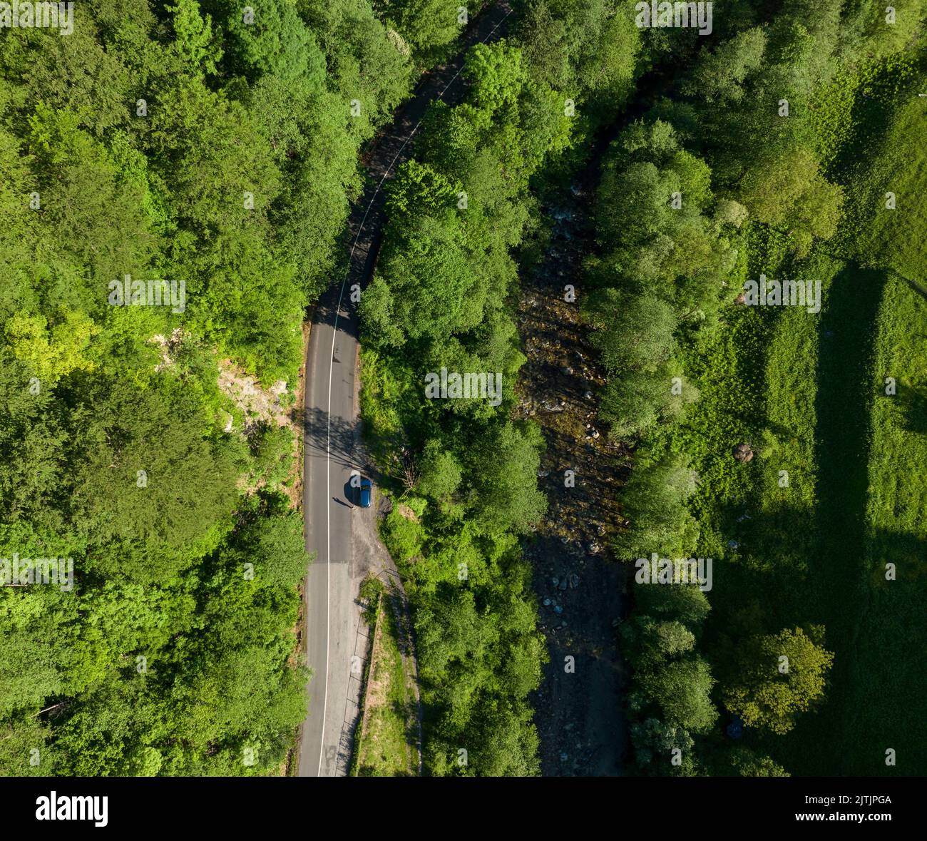 Looking down the road and river - Perspective from drone Stock Photo