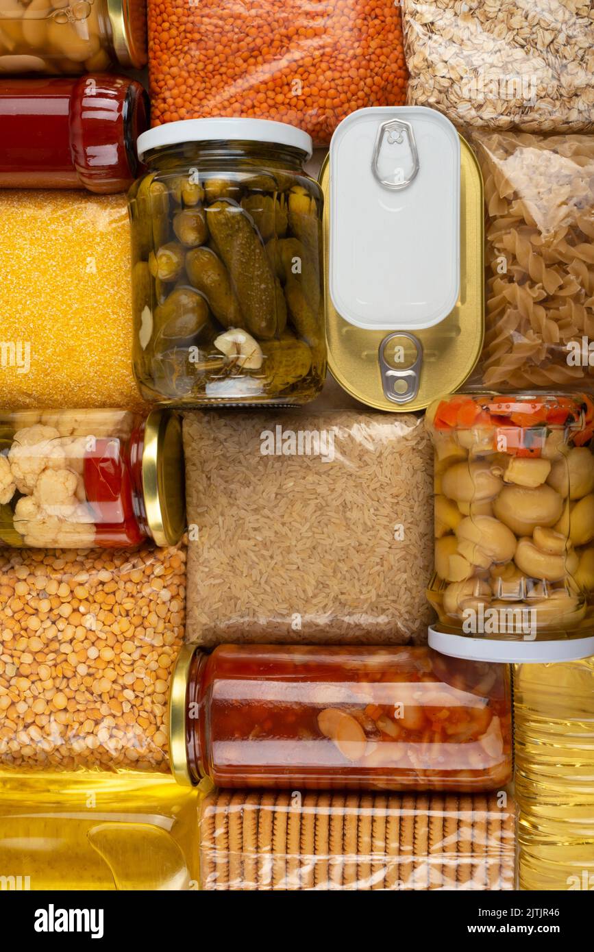 Emergency survival groceries on kitchen table closeup flat lay Stock Photo