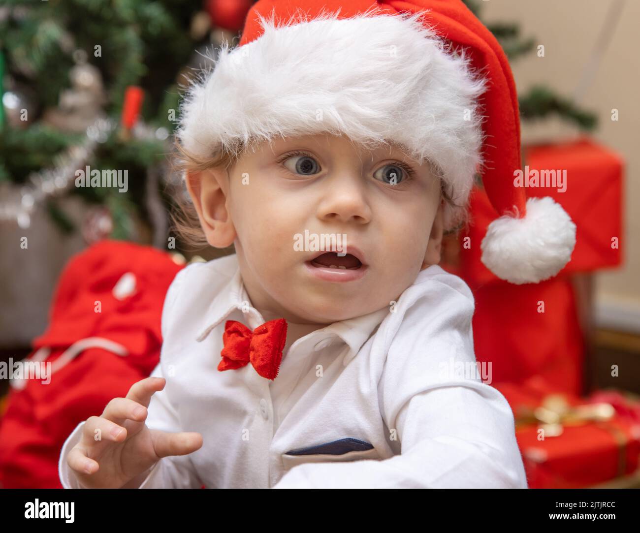 Portrait of a little boy with a Santa Claus hat at Christmas time Stock Photo