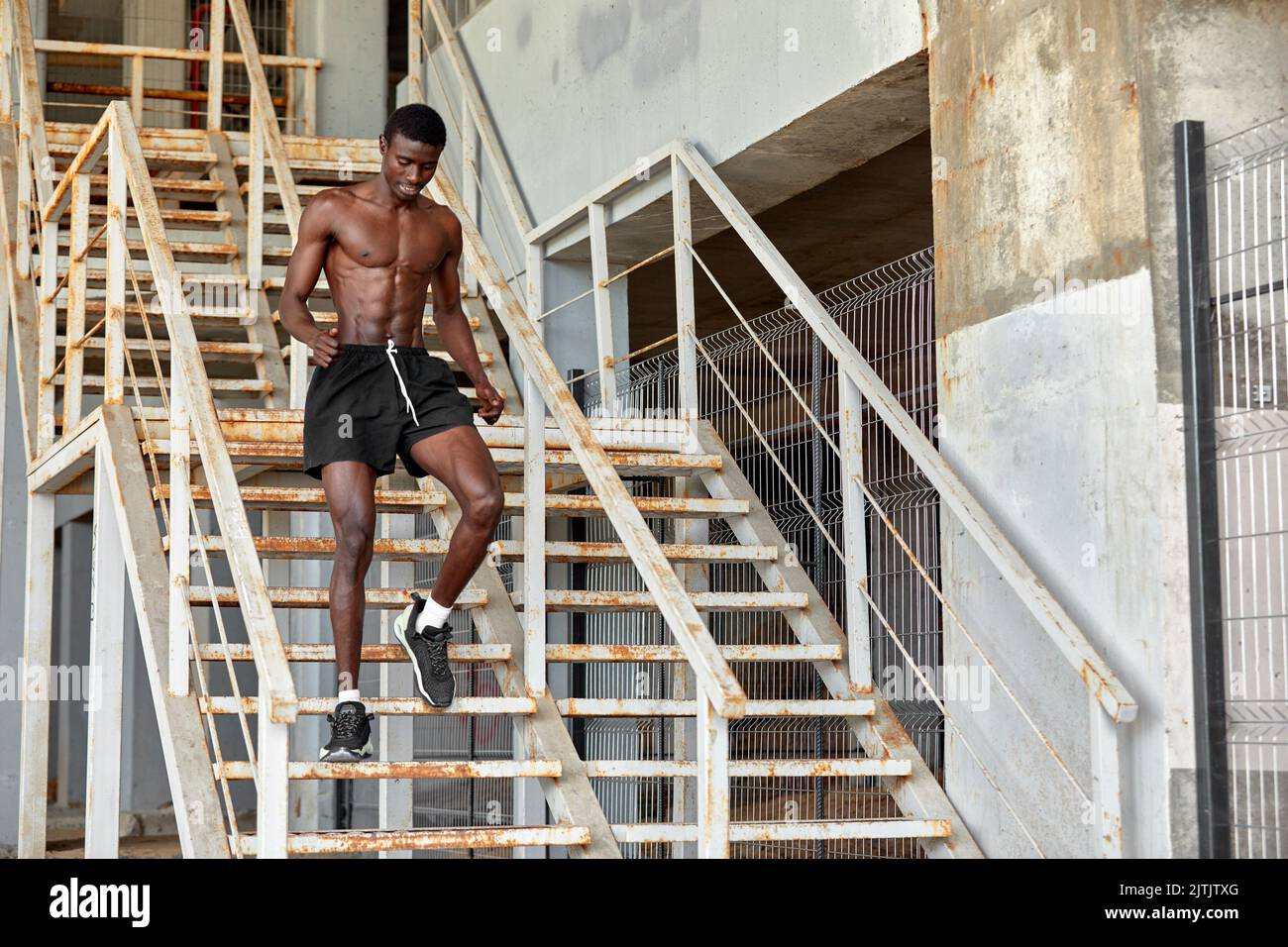Black man running up stairs hi-res stock photography and images - Alamy
