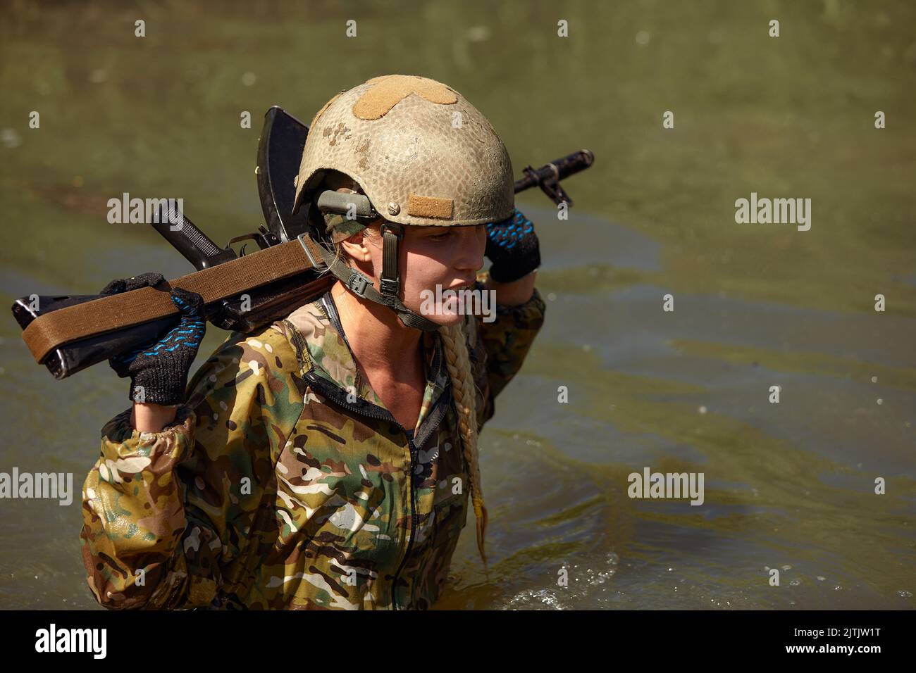 Camouflaged woman sniper in ghillie suit posing with rifle in foggy night.  Special Weapons and Woman Concept Stock Photo - Alamy