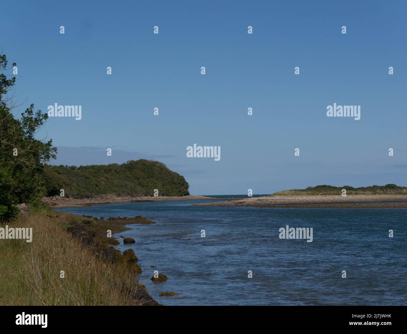 View along Traeth Dulas estuary at high tide towards entrance to Dulas Bay Isle of Anglesey North Wales UK on a lovely sunny August day Stock Photo