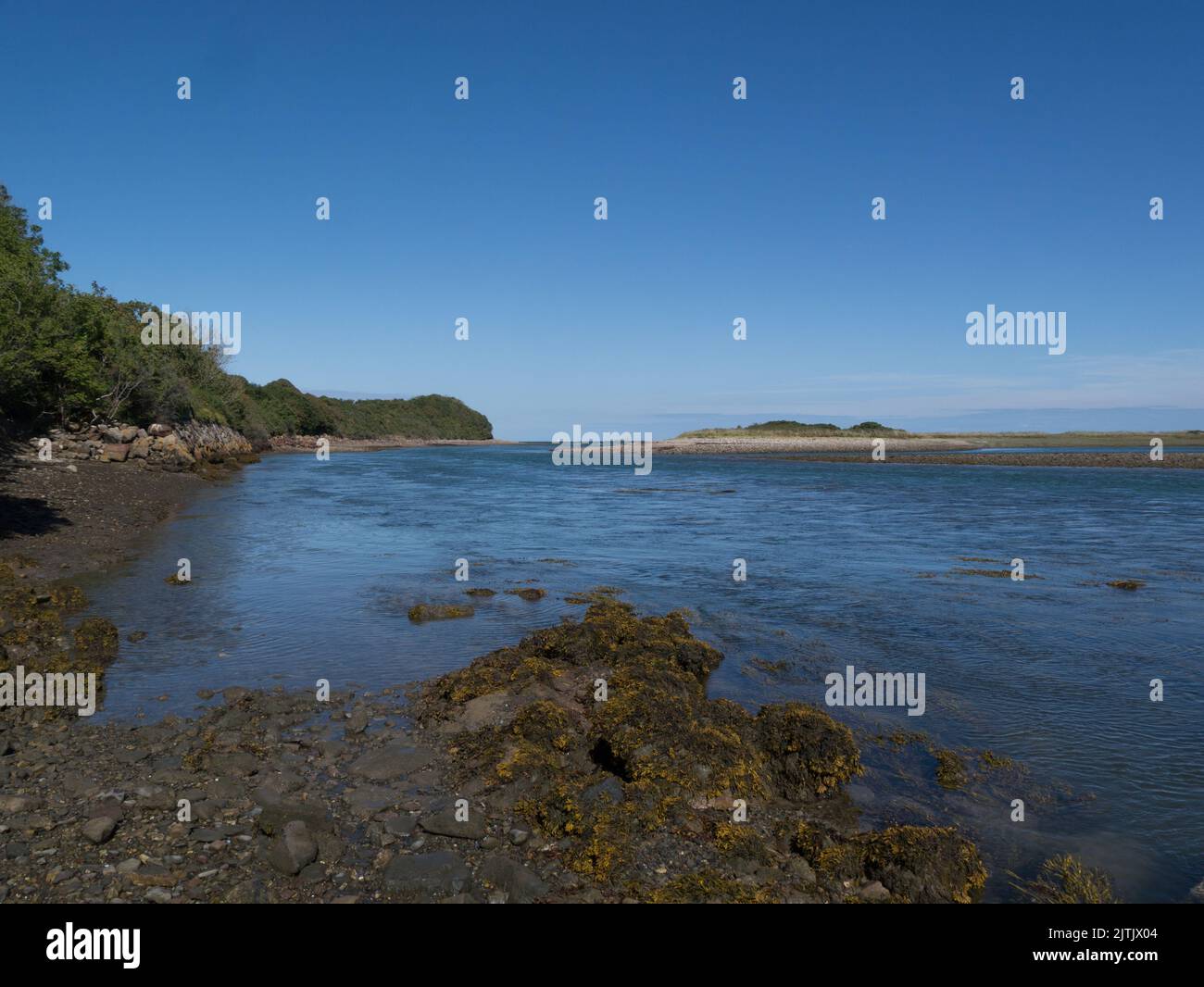 View along Traeth Dulas estuary at high tide towards entrance to Dulas Bay Isle of Anglesey North Wales UK on a lovely sunny August day Stock Photo
