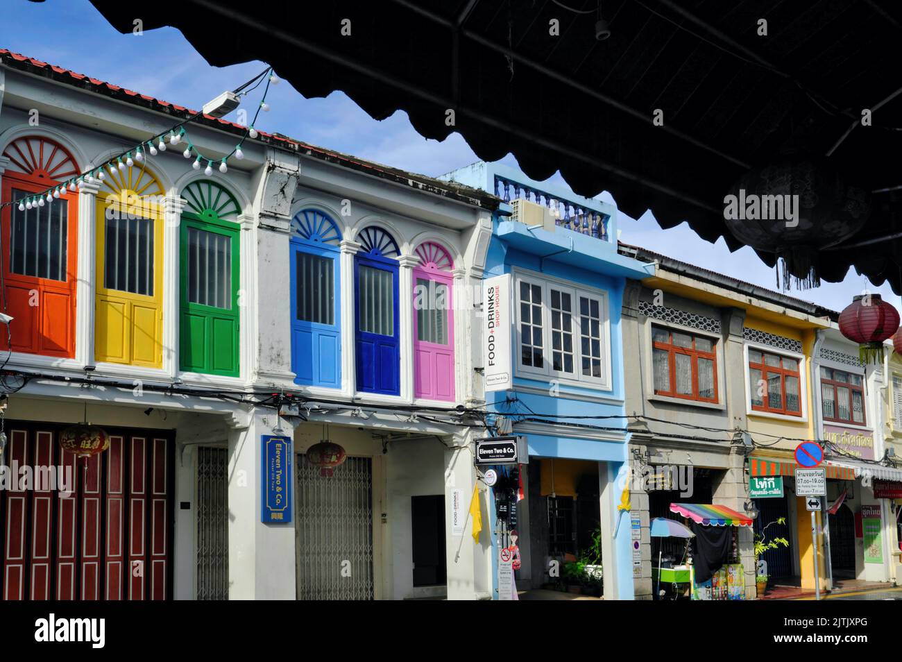 Colourful traditional Sino-Portuguese or Peranakan shophouses in Thalang Road in the Old Town heritage area of Phuket Town, Thailand Stock Photo