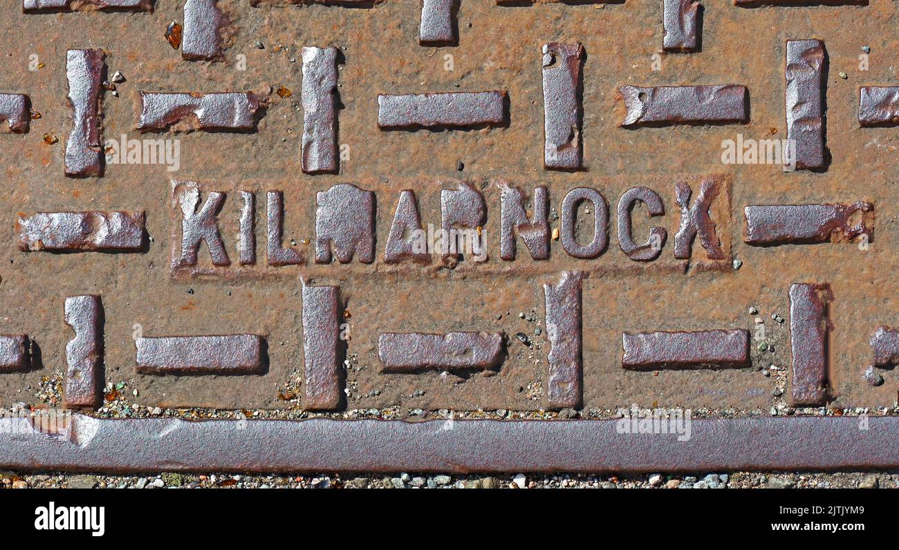 Rusty cast iron utility grid from Kilmarnock, Scotland, UK Stock Photo