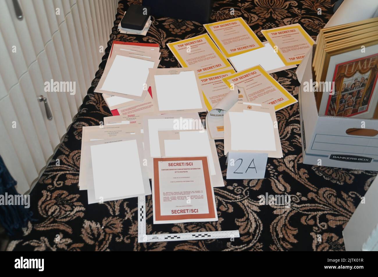In response to a lawsuit by Donald J. Trump, the Department of Justice National Security Division and U.S. Attorney for the Southern District of Florida submitted a filing containing this image, described as 'Redacted FBI photograph of certain documents and classified cover sheets recovered from a container in the '45 office'.' The '45 office' refers to the office of former US President Donald Trump. On August 8, 2022, the Federal Bureau of Investigation (FBI) executed a search warrant at Mar-a-Lago, the Palm Beach, Florida, residence of former U.S. president Donald Trump. Stock Photo