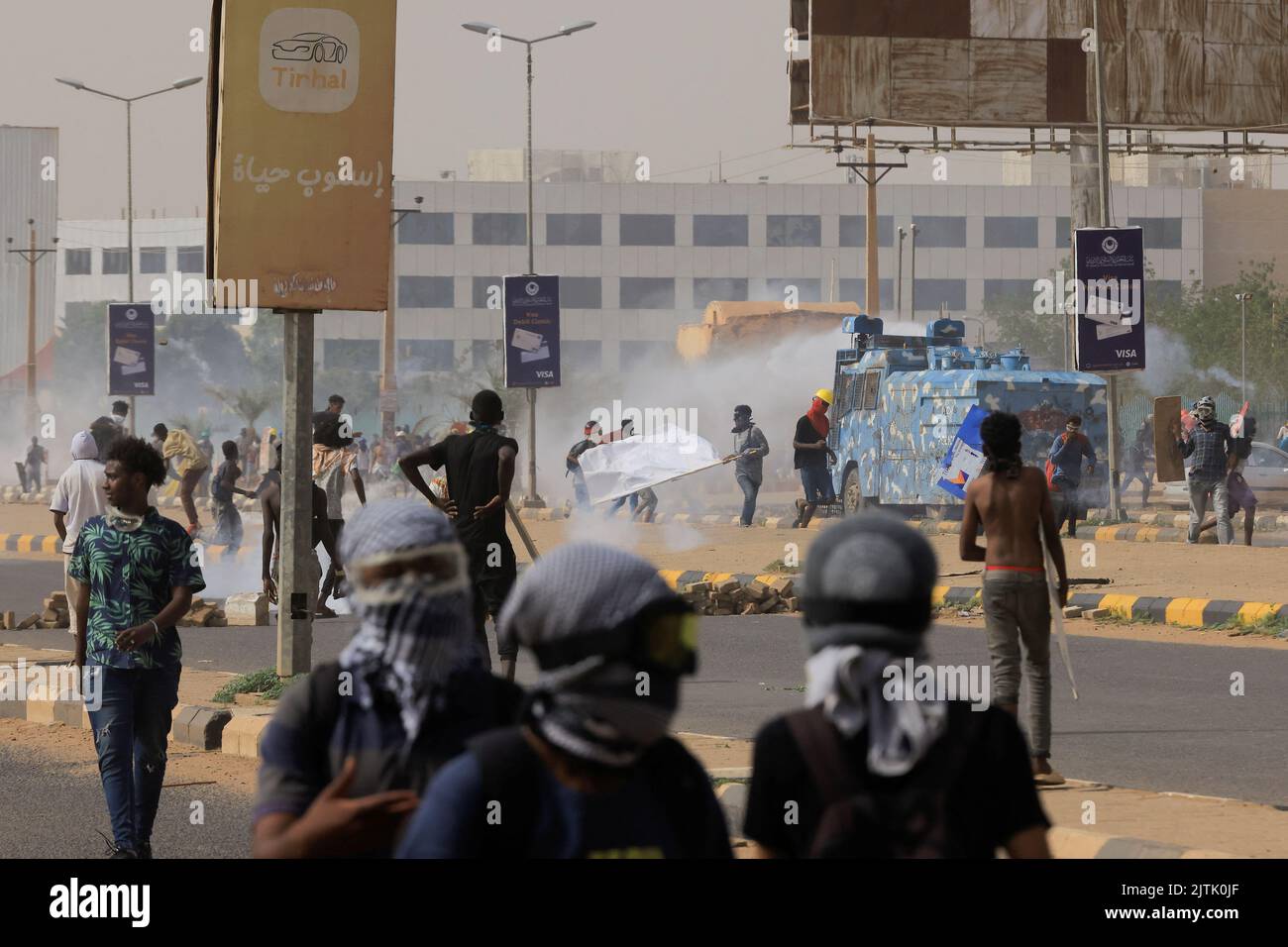 People walk near a police vehicle as protesters march during a rally against military rule following the last coup, in Khartoum, Sudan August 31, 2022. REUTERS/Mohamed Nureldin Abdallah Stock Photo
