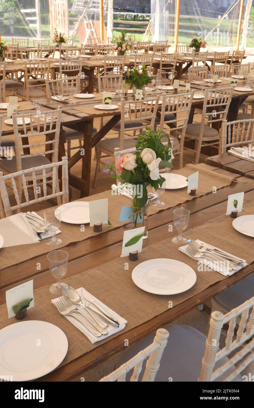 Marquee with tables set for a wedding reception Stock Photo
