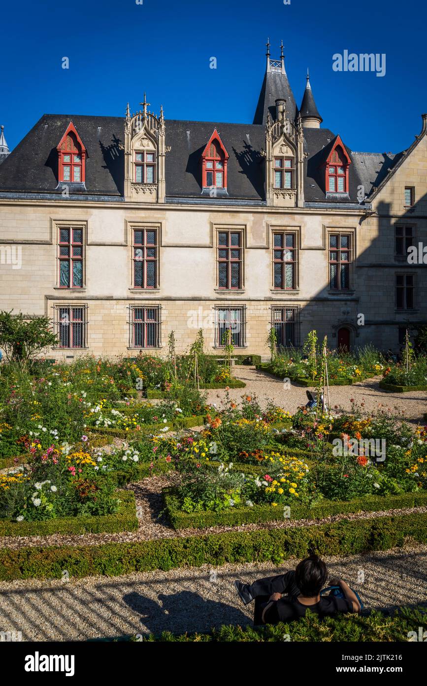 Hôtel de Sens garden, a formal garden with Gothic-style villa with gables and turrets, Paris, France Stock Photo