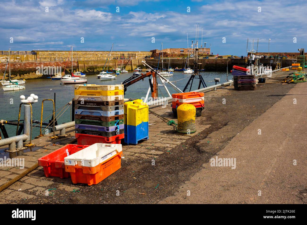 Fish boxes stacked on the quayside at Victoria Harbour, Dunbar, Scotland, UK Stock Photo
