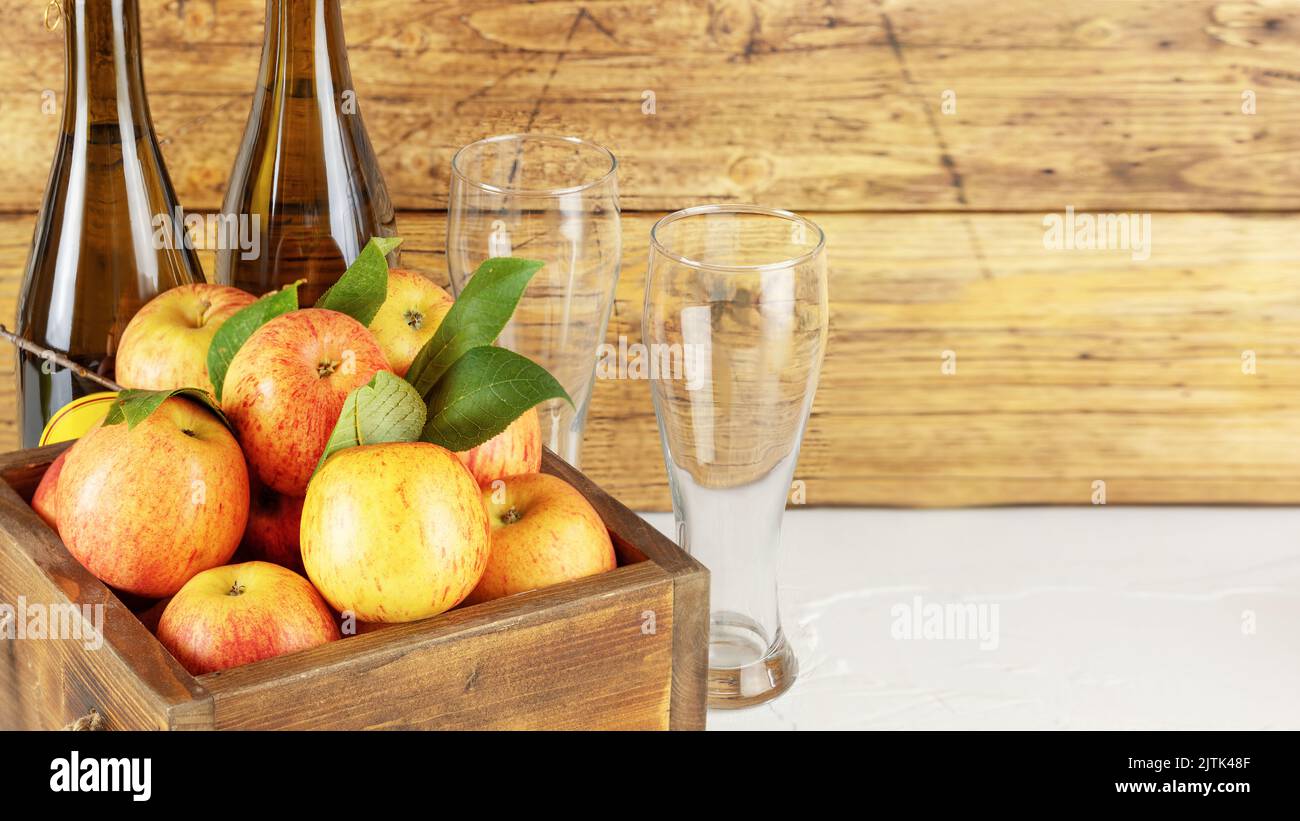 Apple cider drink or fermented fruit drink. Bottles with cider, glasses