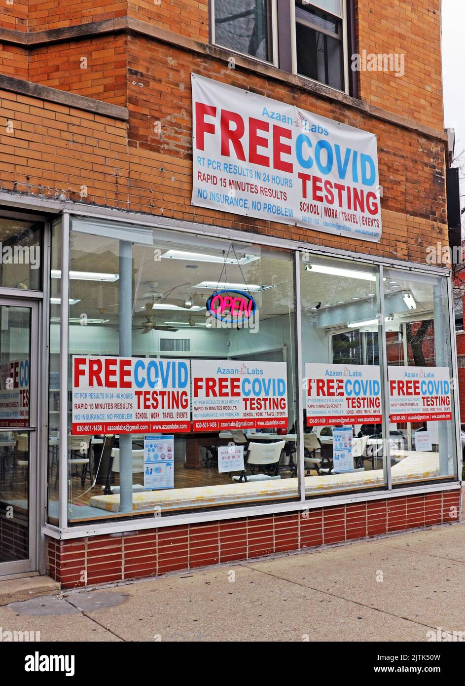 A storefront covered in advertisements stating free Covid testing in Chicago, Illinois, USA on July 16, 2022. Stock Photo