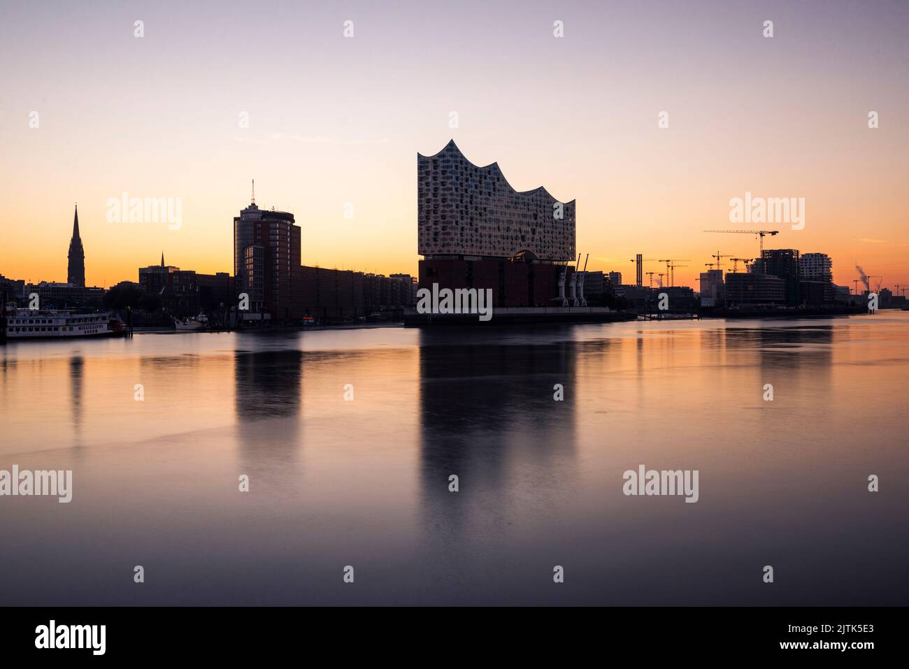 The Elbe Philharmonic Hall and Hamburg skyline reflected in the river Elbe at dawn, Hamburg, Germany Stock Photo